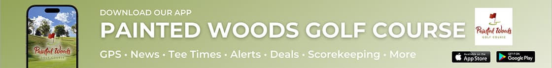 A close-up of a sign displaying the text "DOWNLOAD OUR APP PAINTED WOODS GOLF COURSE -- GPS - News · Tee Times . Alerts - Deals - Scorekeeping · More EL ADO Store" in a clear font.